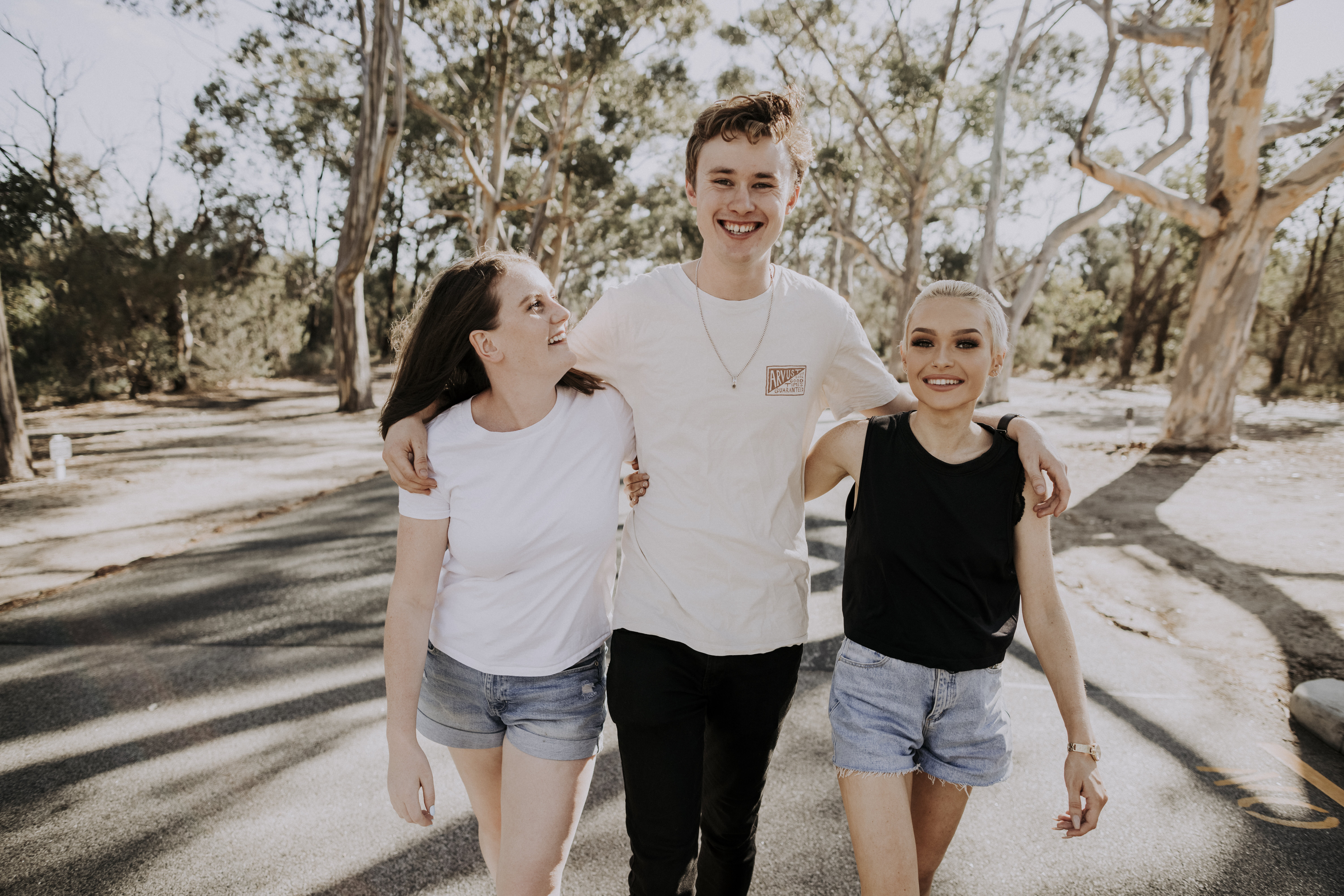 Three young people walking together and smiling