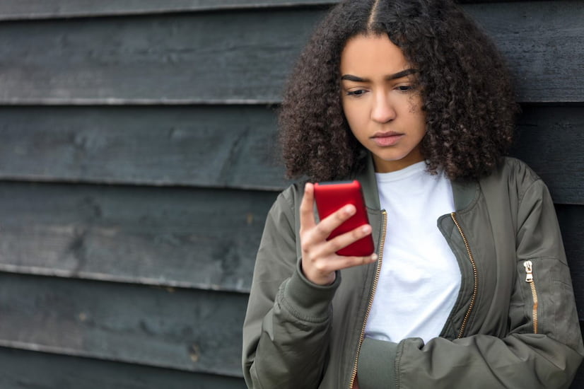 Girl looking for information about cancer on phone