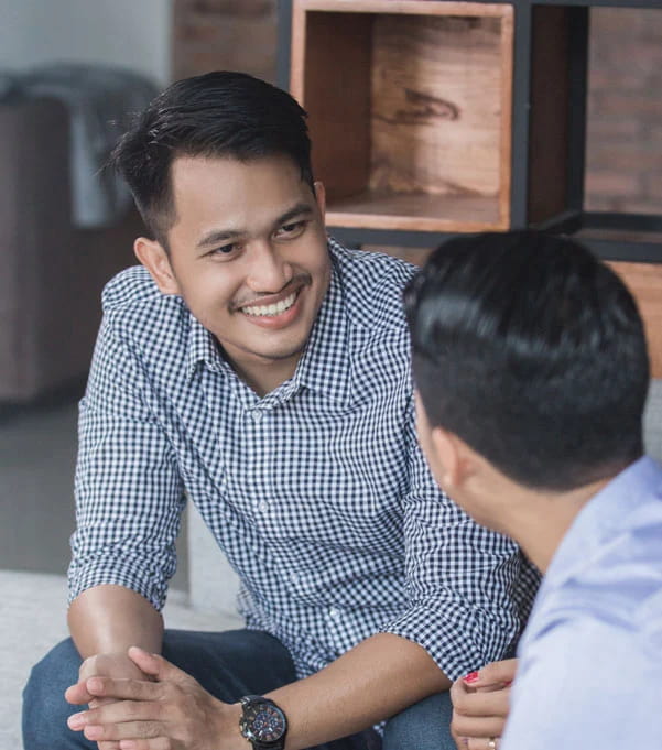 two young men talking in counselling. image for family cancer & support services for cancer patients and families