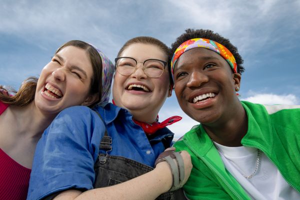 3 young people smiling at the camera wearing bandannas