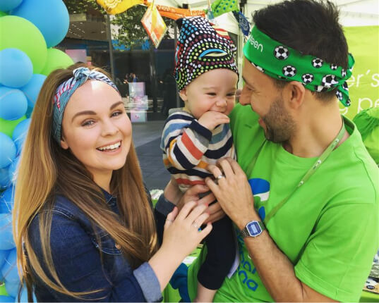 Photo of a mother, father and baby wearing Canteen bandannas smiling