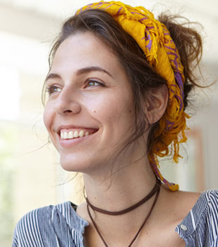 young female supporting a yellow bandana, smiling. image for Canteen's support for cancer patients & cancer support services