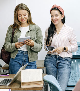 two women on their ipad and phone within an office - supporter care team for charitable donations