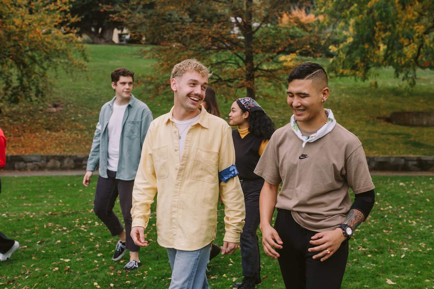 five young people from canteen walking and smiling five young people from canteen walking and smiling