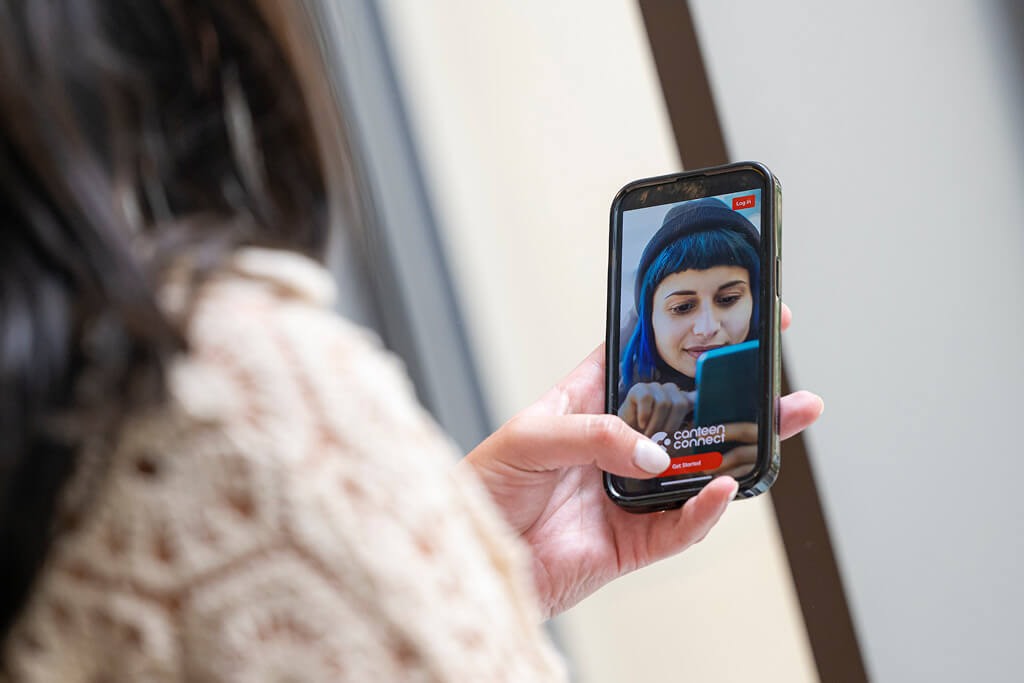 young person using their phone to access canteen connect