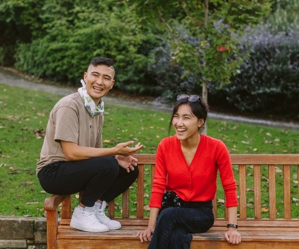 young people sitting in a park together