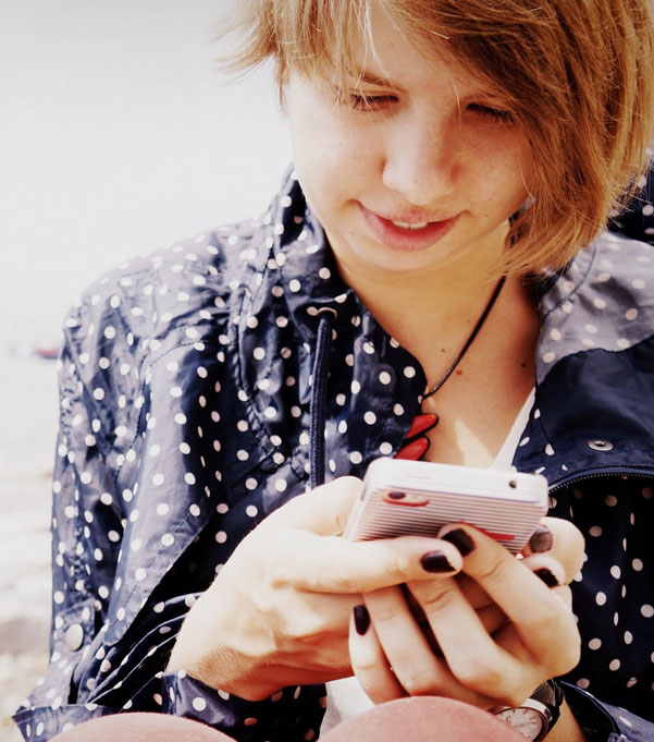 a young person on their phone accessing Canteens online support