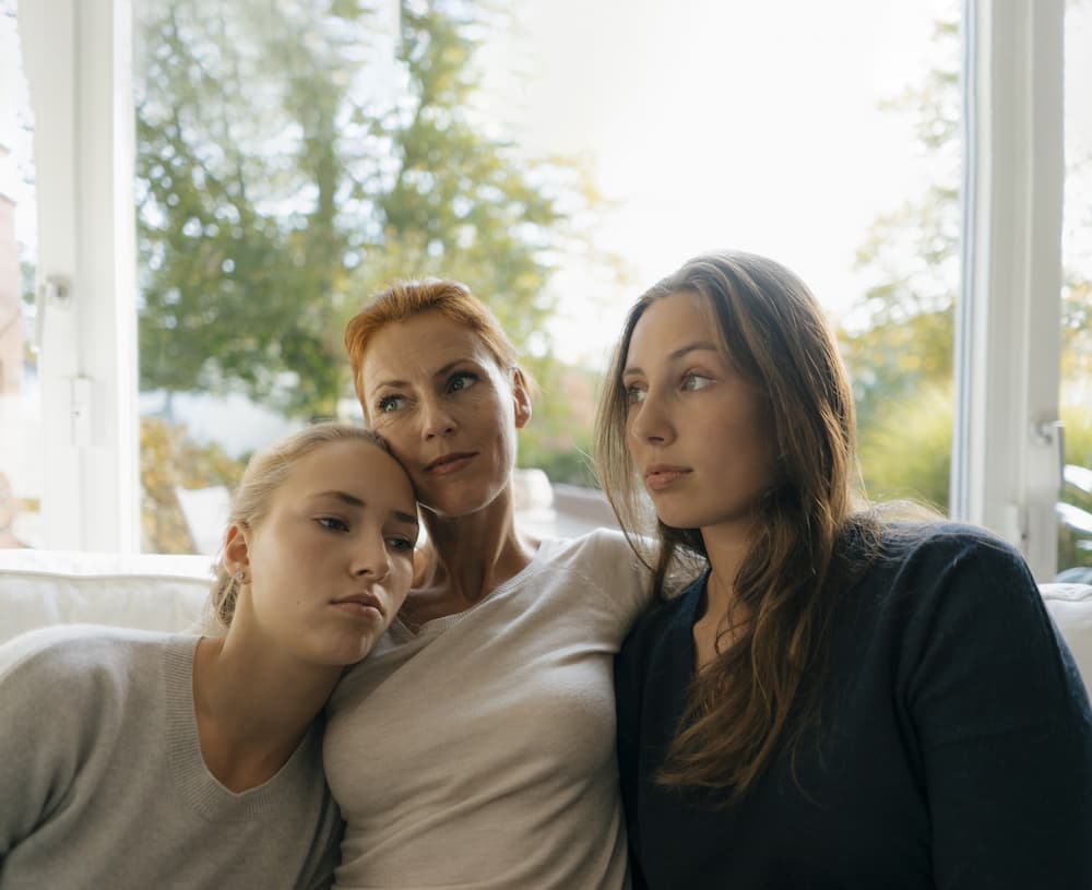 mother and daughters on couch