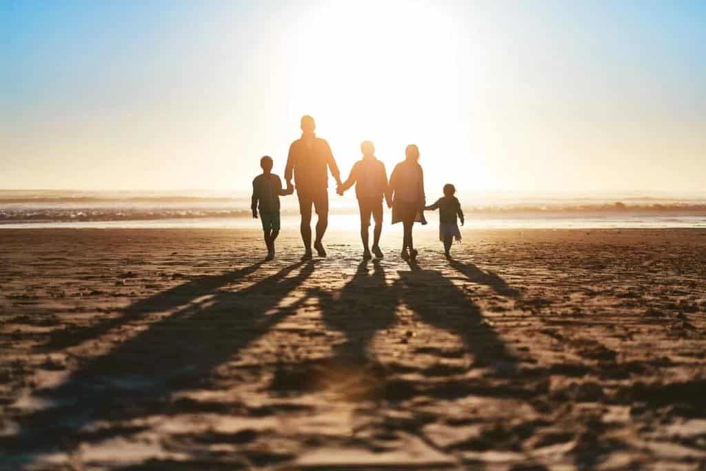 family walking in the sunset