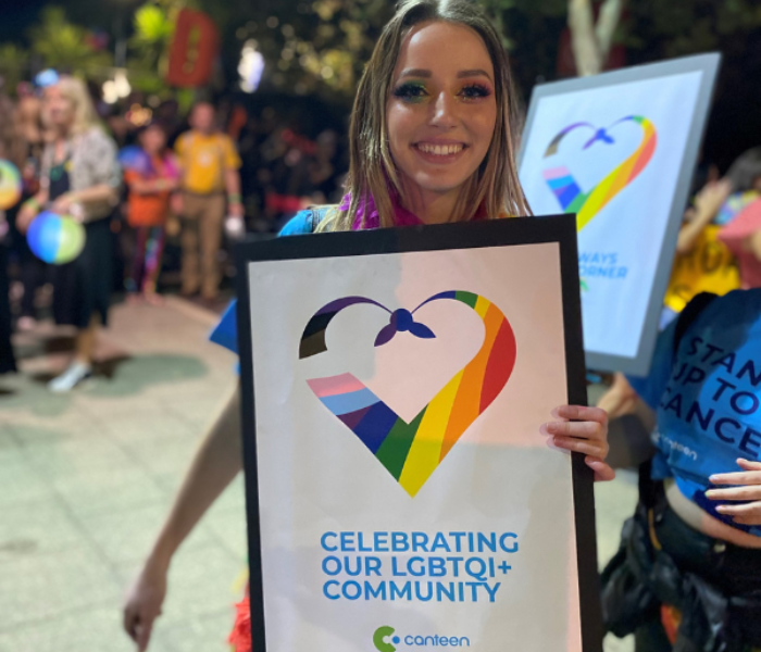 canteen volunteer emily holding a canteen inclusivity sign