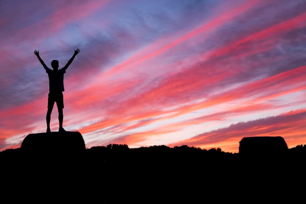 person feeling strong in sunset