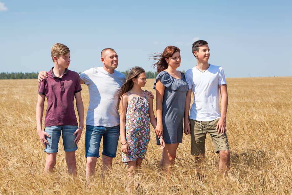 family of five standing in a field