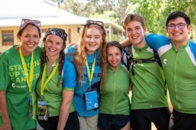 a group of young people posing together smiling