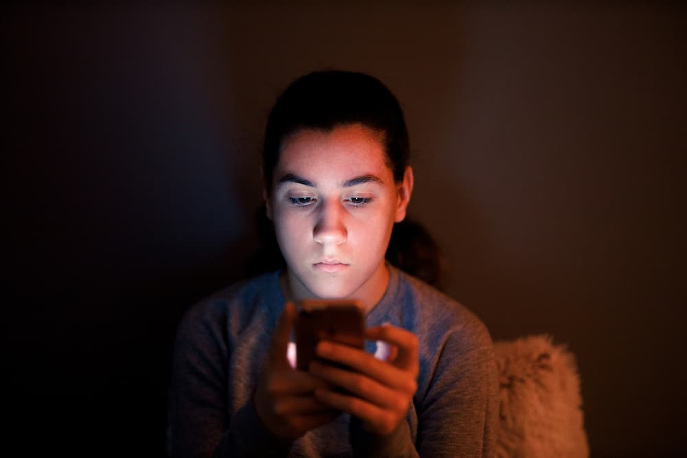 boy staring into phone