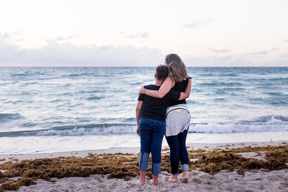 two people looking at the ocean