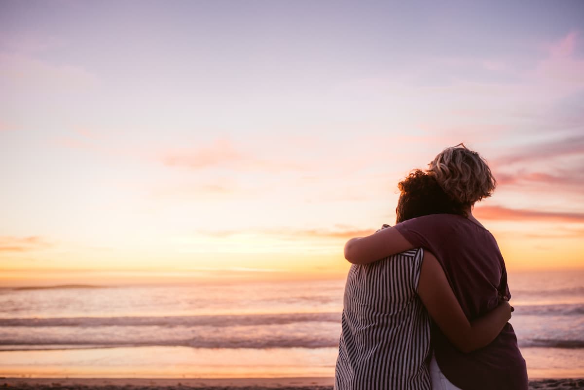 two women comforting each other