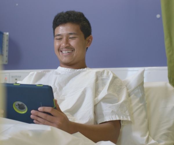 a young person with cancer  in a hospital bed