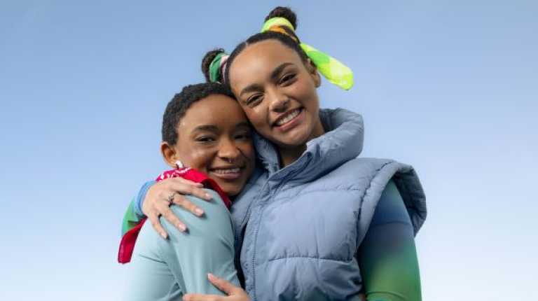 two young people wearing bandannas and embracing