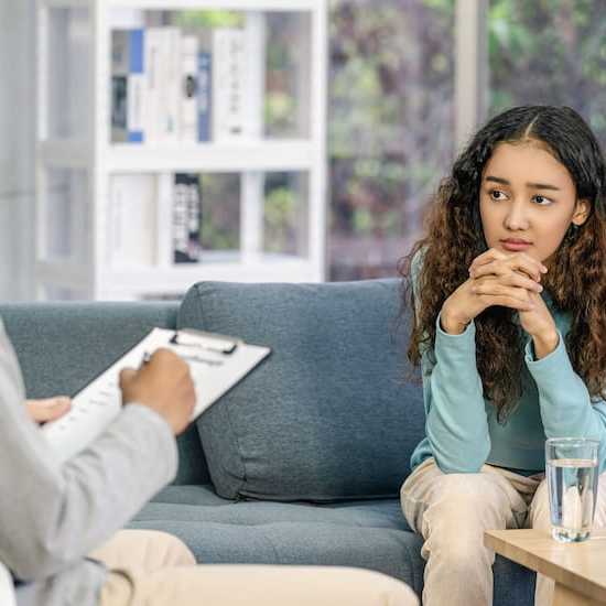 Young woman speaking to specialist