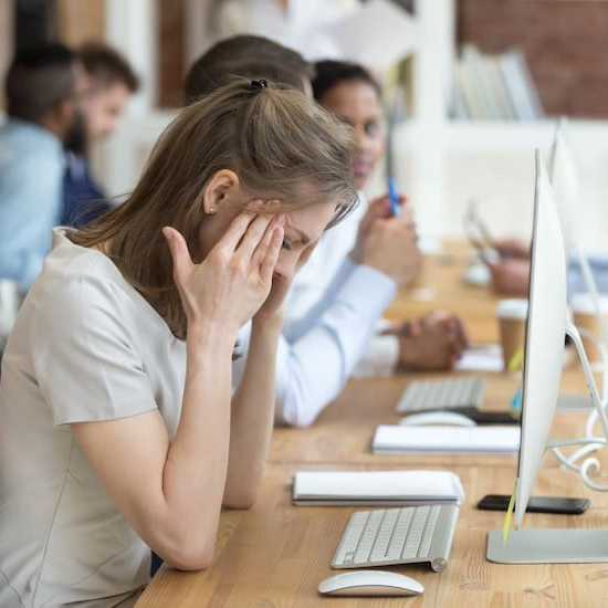 young woman trying to cope at work