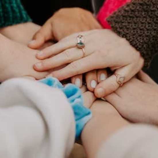 a group of hands joining together as a team