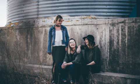 three young female students hanging out and talking