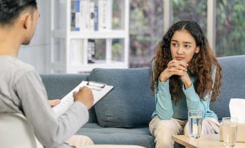 Young woman speaking to specialist