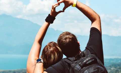 couple making a heart shape with their hands