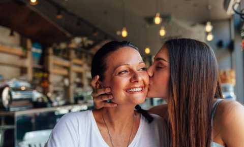 Daughter kisses Mother who has cancer