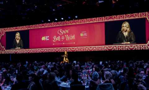 Sally speaking on stage at the Tour de Cure gala event