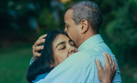 Two people embrace