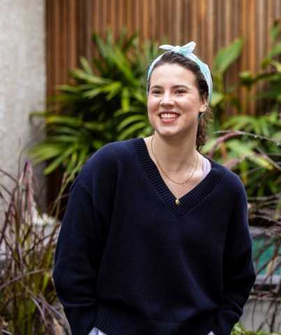 Image of Saskia, a young person who has benefited from Canteen's free cancer support services, standing in a garden
