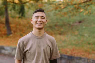 young person smiling in the park