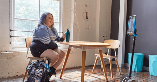 Girl sitting on a desk utilizing Canteen's robots service