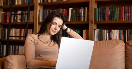 young person reading about cancer information on their laptop