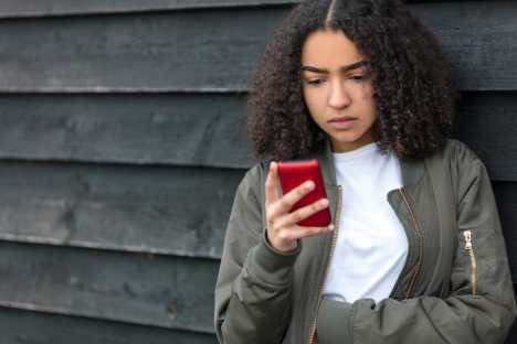 Girl seeking information about cancer on phone