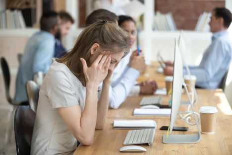 young woman trying to cope at work