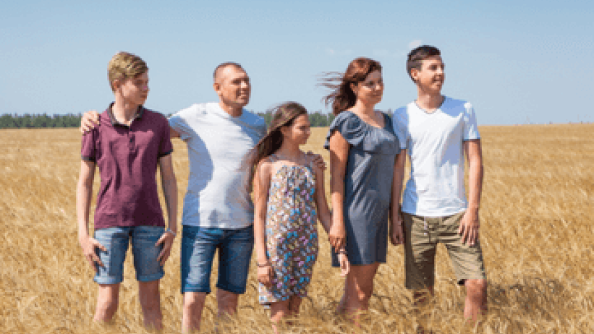 Family standing in field
