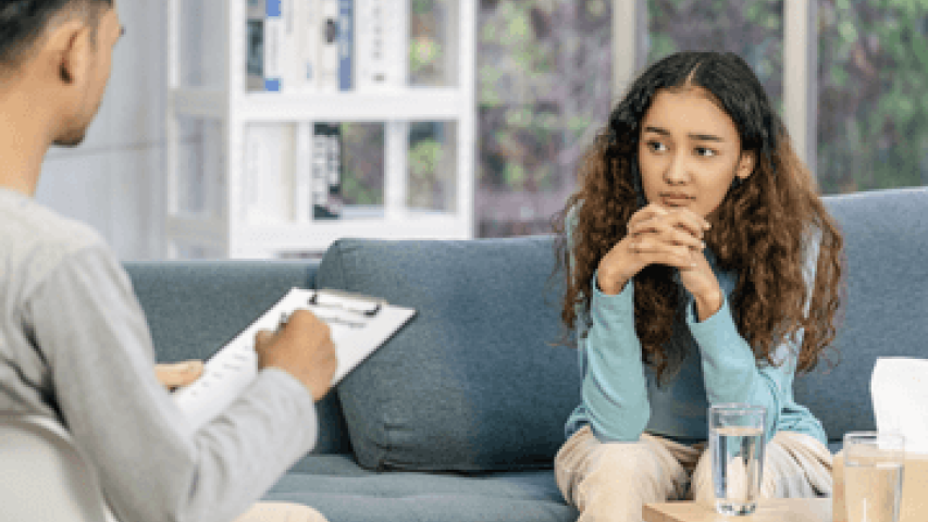 Young woman speaking to specialist