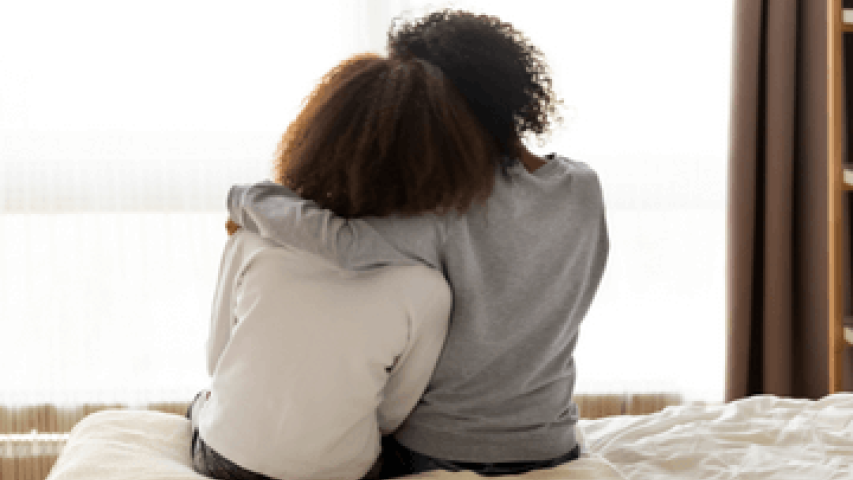 Friends consoling each other