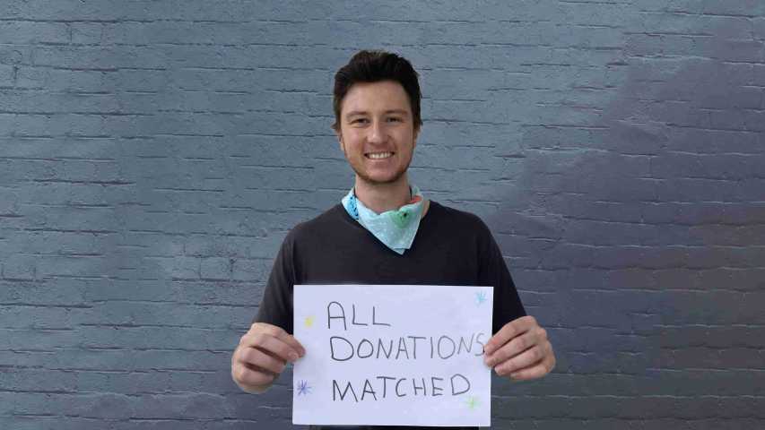 young person affected by cancer holding a sign that says all donations matched