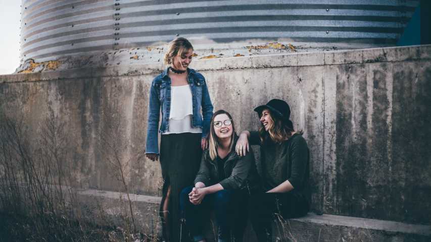 three young female students hanging out and talking