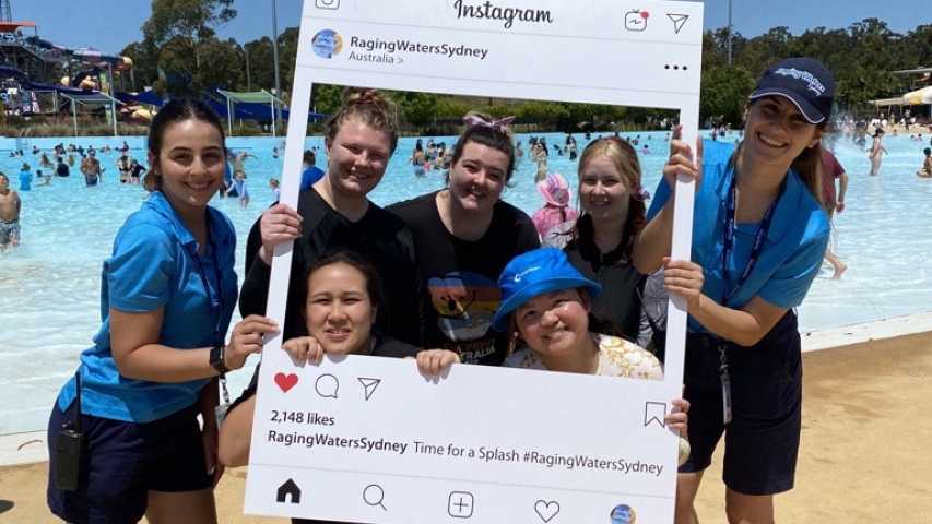 raging waters sydney staff with young people impacted by cancer in front of a pool