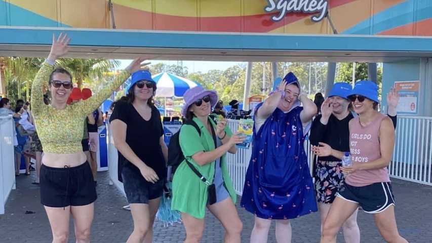 young people impacted by cancer having fun in front of the raging waters park entry