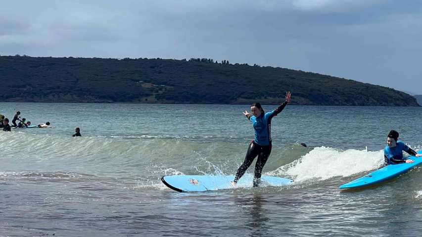 young person trying surfing at dodges ferry