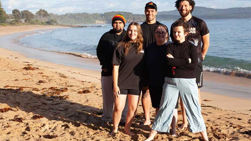 six young people standing on the beach at canteen's first nations cultural program