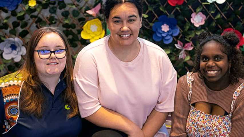 three young women smiling 
