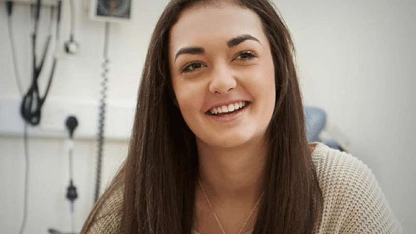 young girl smiling receiving support from youth cancer services