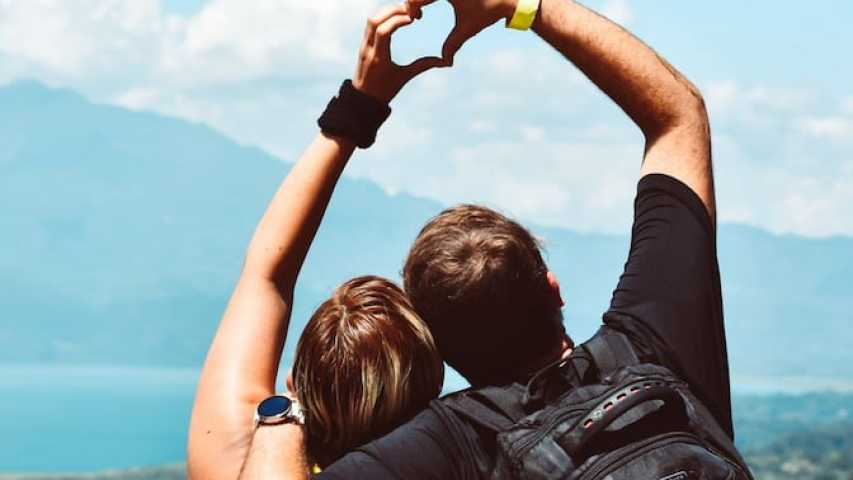 couple making a heart shape with their hands