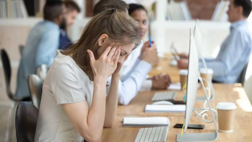 young woman trying to cope at work